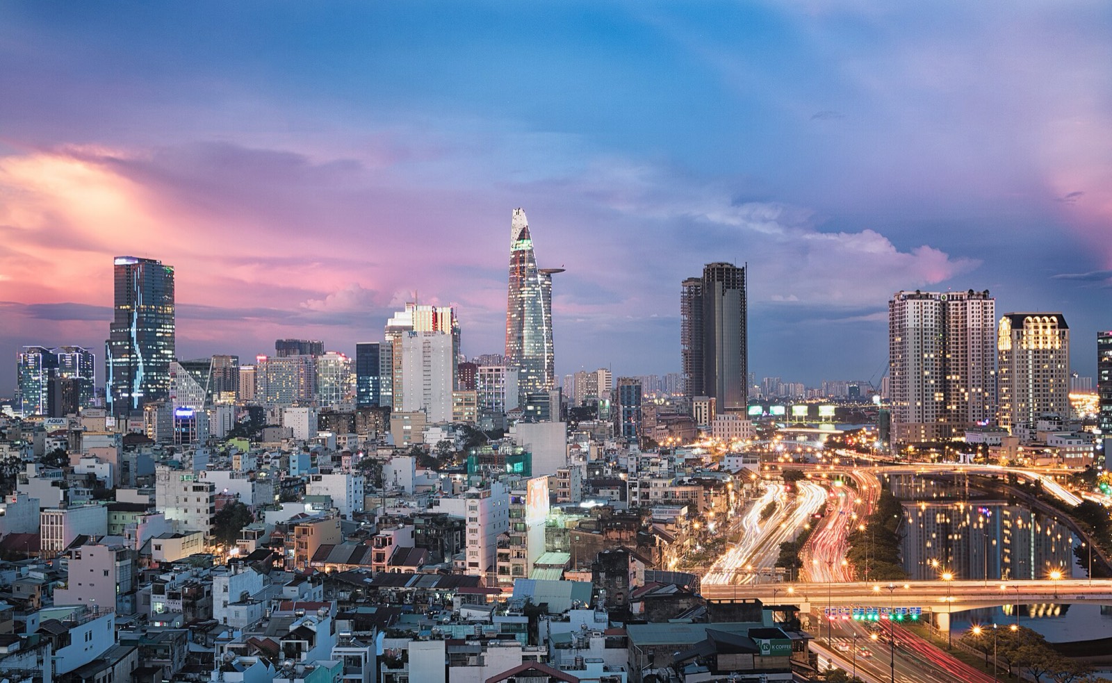 Ho Chi Minh City at sunset, the river and towers of District 1